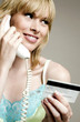 Woman using credit card over the telephone