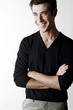 Man folding his arms while smiling