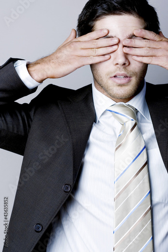 Photo: Businessman closing his eyes with his hands Businessman closing his eyes with his hands