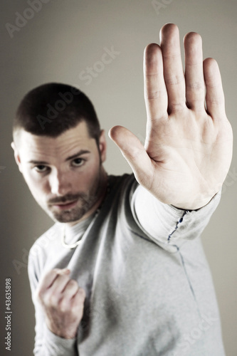 Photo: Man showing a stop sign Man showing a stop sign