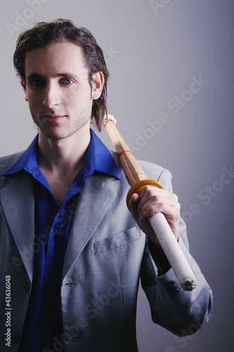Photo: Businessman holding a sword Businessman holding a sword