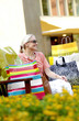 Woman with paper bags sitting on the bench