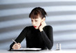 Woman writing in her organizer