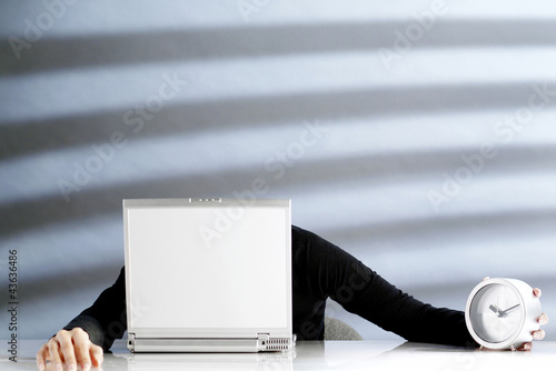 Photo: Businesswoman dozing off on a laptop Businesswoman dozing off on a laptop