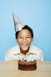 Boy posing with his birthday cake