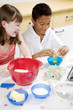 Boy and girl baking cake in the kitchen