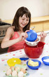 Girl baking cake in the kitchen
