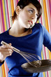 Woman talking on the phone while cooking