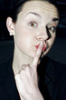 Businesswoman showing a hushing sign