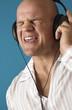 Man closing his eyes while listening to music on the headphones