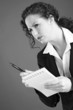 Businesswoman holding a pen and a notepad