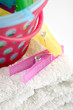 Colourful plastic clothes pegs and basket