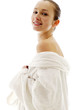 Woman in white bathrobe smiling at the camera