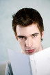Man looking at the camera while reading