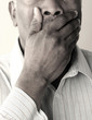 Senior man covering his mouth