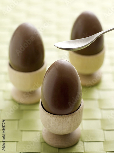 Photo: Chocolate eggs in egg cups Chocolate eggs in egg cups