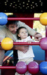 Father and daughter playing with abacus in the playground