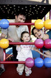 Parents and daughter playing with abacus in the playground