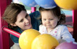 Mother and daughter playing with abacus in the playground