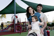 Parents and daughter playing in the playground