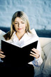 A business lady reading on a couch