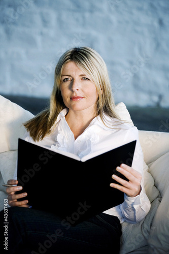 Photo: A business lady holding an organizer A business lady holding an organizer