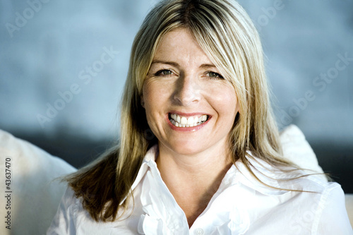 Photo: A happy business lady looking at the camera A happy business lady looking at the camera