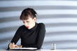 Businesswoman writing on organiser