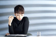 Businesswoman holding pen while reading her organiser