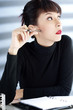 Businesswoman holding a pen and looking away