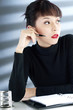Businesswoman holding a pen and looking away