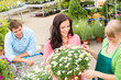 Florist assist woman choose flowers garden store