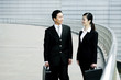Businessman and businesswoman talking to each other