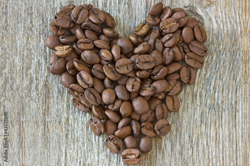 Photo: coffe beans heart on wood background coffe beans heart on wood background