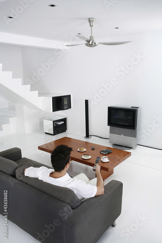 Photo: Man watching television in the living room Man watching television in the living room