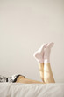 Woman wearing socks relaxing on bed