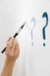 Foto: Drawing question mark on white wall Drawing question mark on white wall
