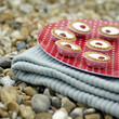 A tray of Bakewell tarts on a folded picnic blanket