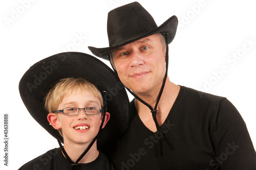 Photo: man and child with cowboy hats man and child with cowboy hats