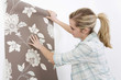 Woman holding wallpaper