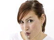 Woman with forefinger on her lips