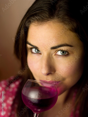 Photo: Woman taking a sip of drink Woman taking a sip of drink