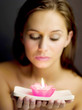 Woman holding a lighted aromatherapy candle