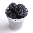Close up of some blackberries in a container