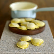 Fresh tortellini pasta on wooden board