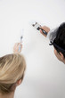 Couple painting the wall