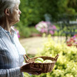 Senior lady holding a basket of fruits
