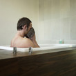 A man wiping his face with a face towel