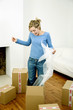 Woman standing in a box holding bubble pack