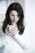 A woman holding a cup of tea